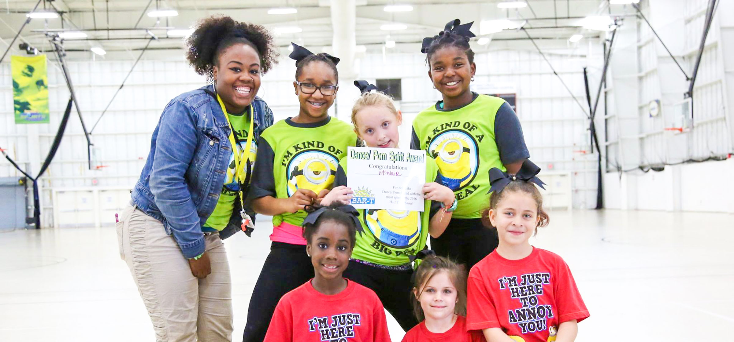 Cheerleading team taking a group photo in a gym