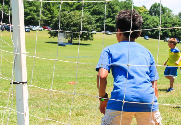 Boy playing soccer goalie during a soccer match