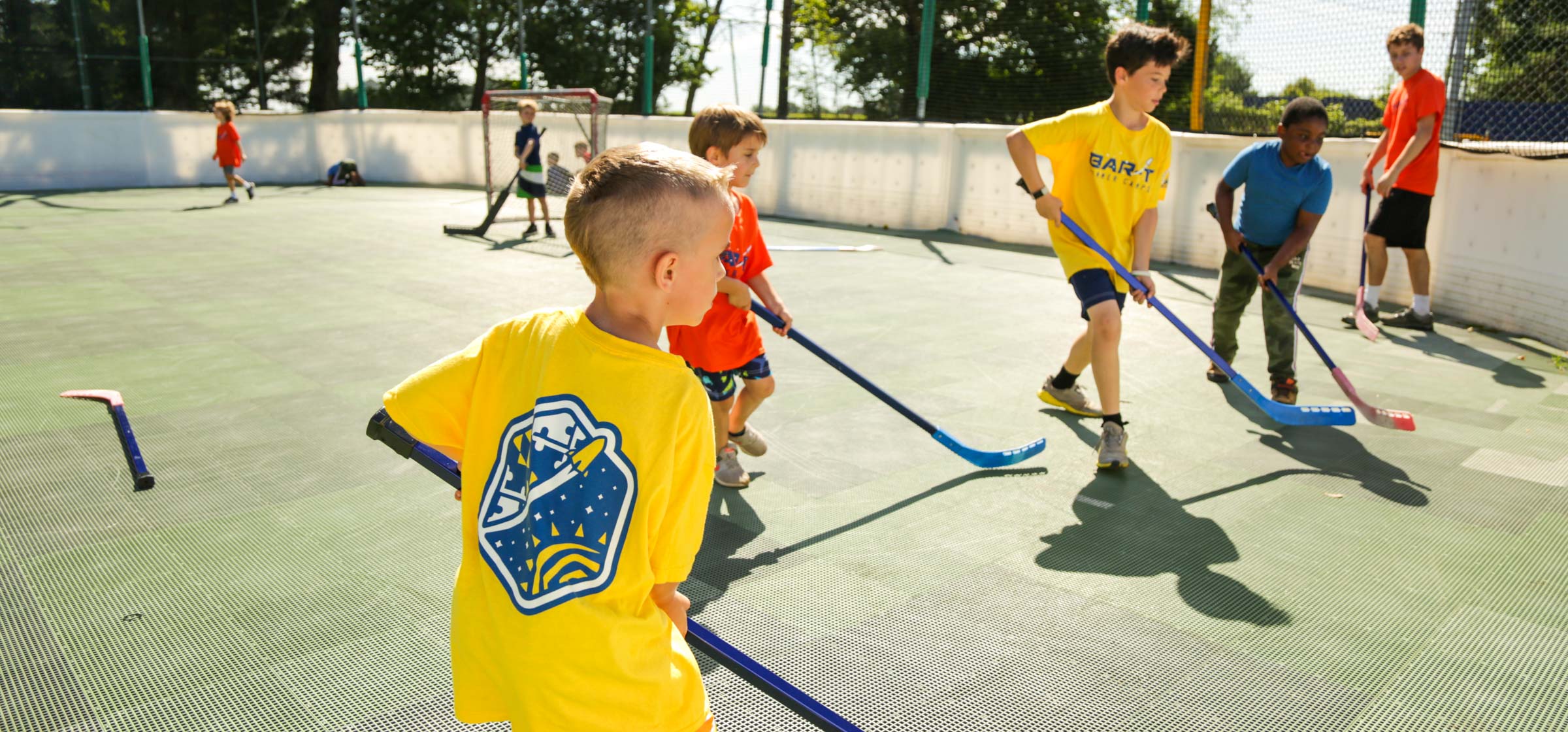 Campers playing street hockey